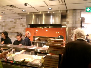 behind the counter at blaze pizza showing the stainless steel fire oven